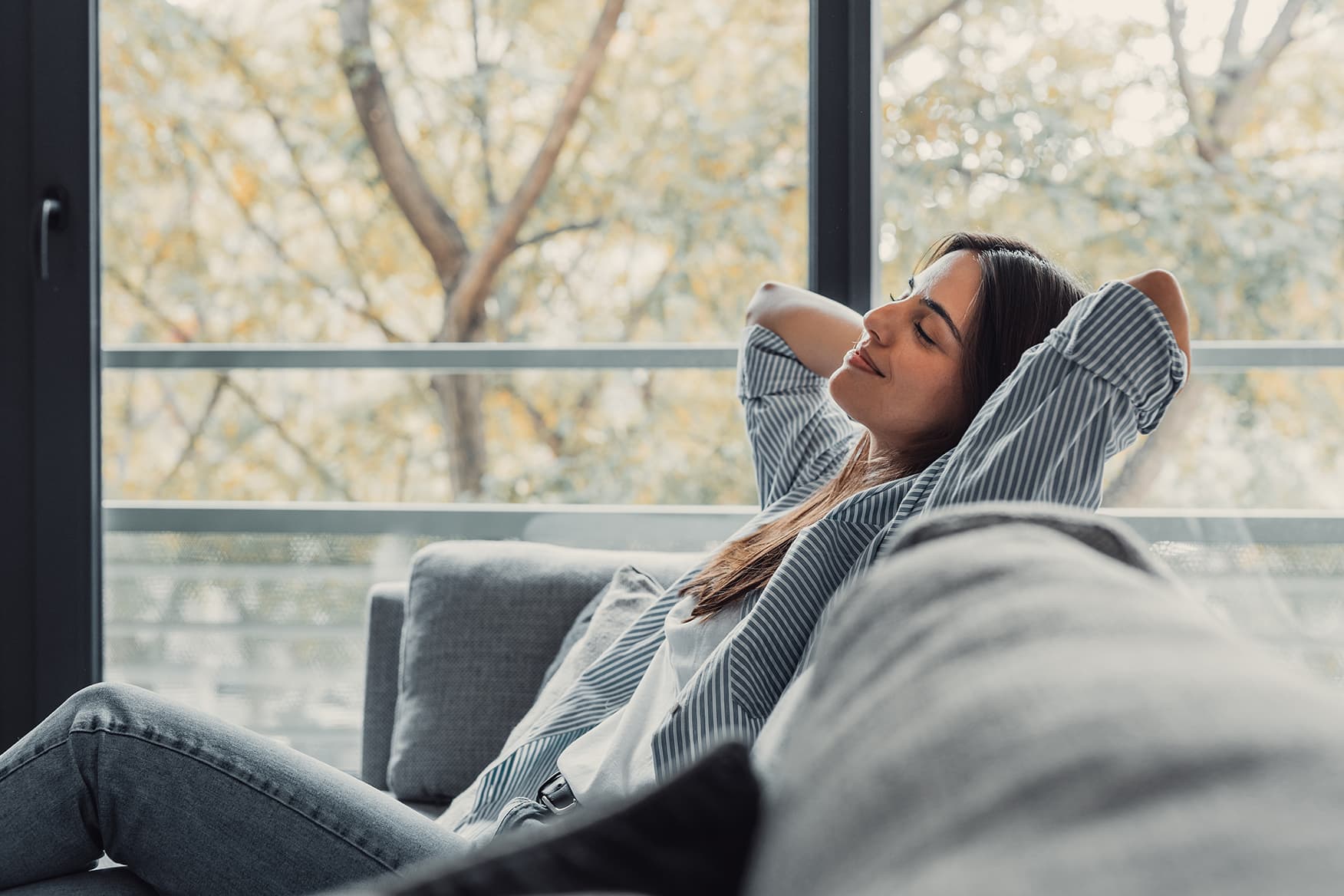 A woman sitting on a comfortable couch